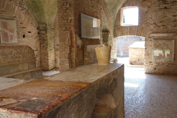 Ancient Ostia Antica Semi-Private Day Trip from Rome by Train with Guide - Mosaics, shops, and the Roman home